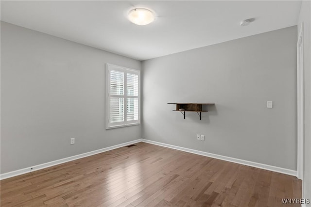 29 Raine Dr, Amherst, NY 14221 - empty room with wood finished floors and a smoke detector