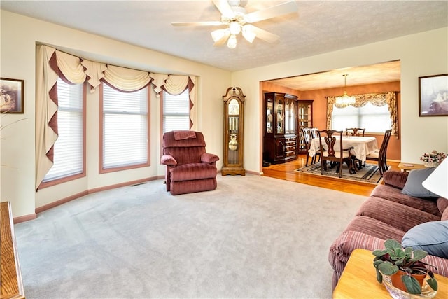 35 Silkwood Cir, Gates, NY 14559 - carpeted living room with a chandelier and ceiling fan