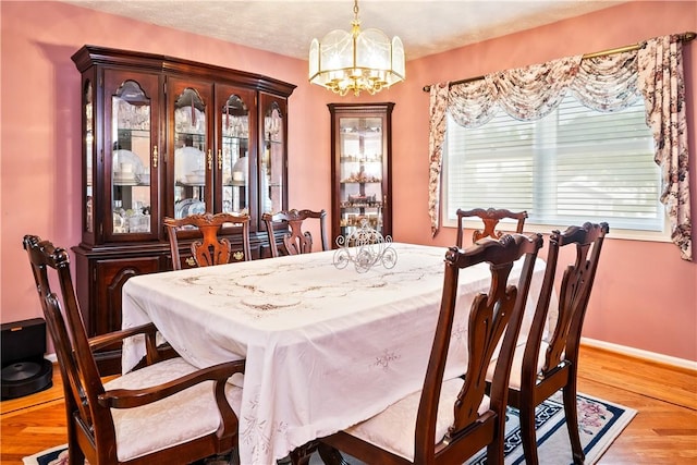 35 Silkwood Cir, Gates, NY 14559 - dining area featuring wood finished floors and a chandelier