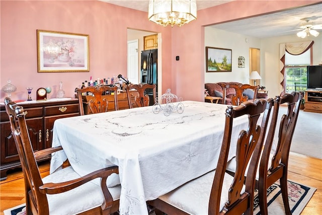 35 Silkwood Cir, Gates, NY 14559 - dining room with light wood-style flooring, ceiling fan, and a chandelier