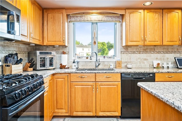 35 Silkwood Cir, Gates, NY 14559 - kitchen with black appliances, light stone counters, backsplash, and brown cabinetry