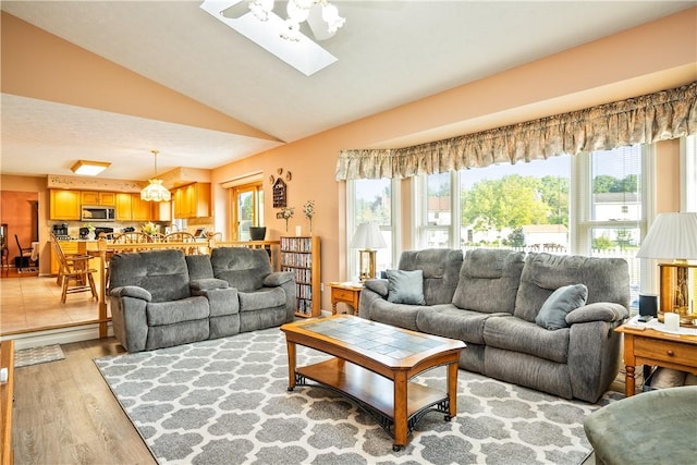 35 Silkwood Cir, Gates, NY 14559 - living room with light wood-style flooring, healthy amount of natural light, lofted ceiling, a chandelier, and a skylight