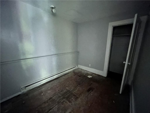 182 Parsells Ave, Rochester, NY 14609 - unfurnished bedroom with a baseboard heating unit and a closet