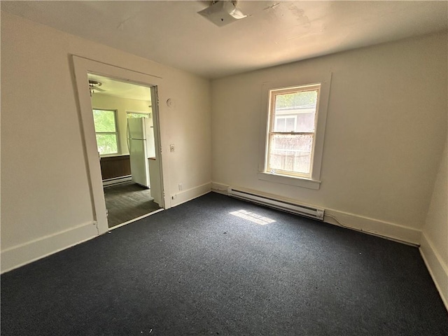 182 Parsells Ave, Rochester, NY 14609 - spare room featuring baseboard heating and dark carpet