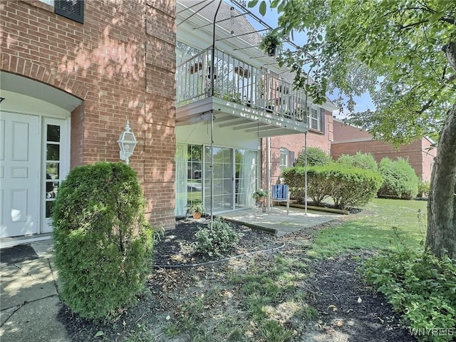 27 Hickory Hill Rd Unit B, Amherst, NY 14221 - view of property exterior featuring a balcony, brick siding, and a patio area