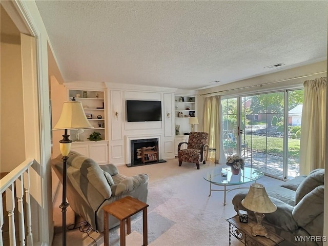 27 Hickory Hill Rd Unit B, Amherst, NY 14221 - living area featuring a textured ceiling, carpet, built in features, and a fireplace with raised hearth