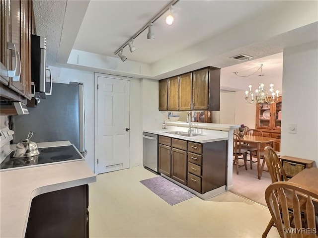 27 Hickory Hill Rd Unit B, Amherst, NY 14221 - kitchen featuring stainless steel appliances, a chandelier, light countertops, and rail lighting