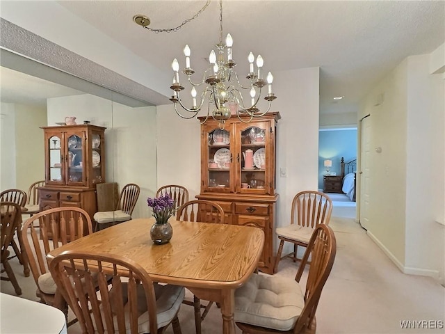 27 Hickory Hill Rd Unit B, Amherst, NY 14221 - dining area with light carpet and a chandelier