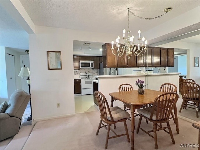27 Hickory Hill Rd Unit B, Amherst, NY 14221 - dining room with a chandelier, light carpet, and a textured ceiling