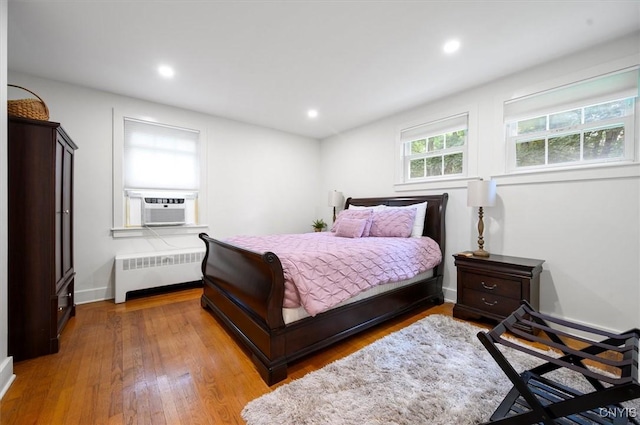 53 Payne St, Hamilton, NY 13346 - bedroom with radiator, cooling unit, wood finished floors, and recessed lighting