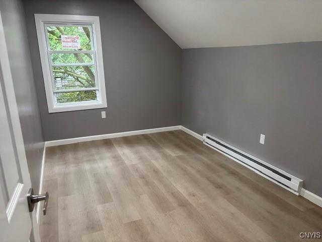 196 Berger Ave, Syracuse, NY 13205 - bonus room featuring baseboard heating, vaulted ceiling, and wood finished floors