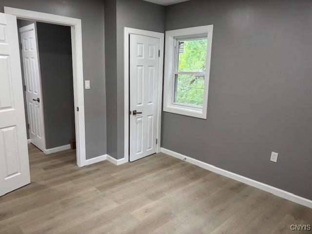 196 Berger Ave, Syracuse, NY 13205 - unfurnished bedroom featuring baseboards and light wood-type flooring