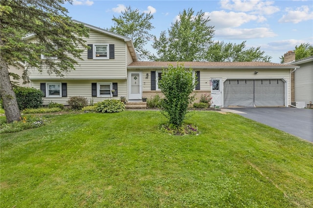 29 Davy Dr, Gates, NY 14624 - tri-level home featuring driveway, a front yard, a garage, and brick siding