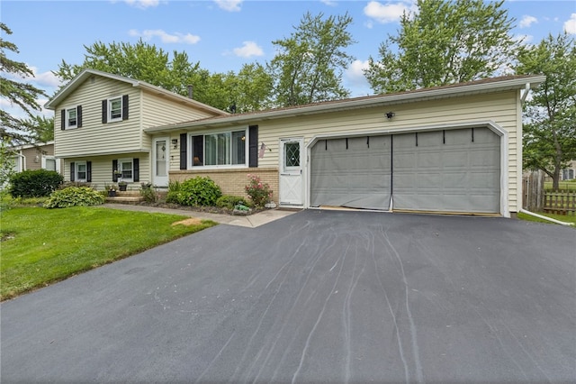 29 Davy Dr, Gates, NY 14624 - tri-level home with driveway, brick siding, a front lawn, and an attached garage