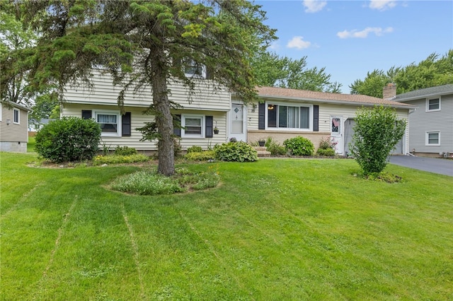 29 Davy Dr, Gates, NY 14624 - tri-level home featuring a front lawn, a garage, and asphalt driveway