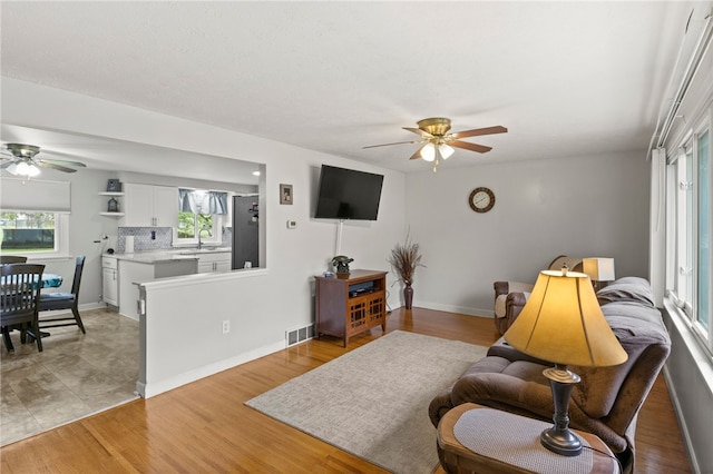 29 Davy Dr, Gates, NY 14624 - living area featuring a ceiling fan and light wood finished floors