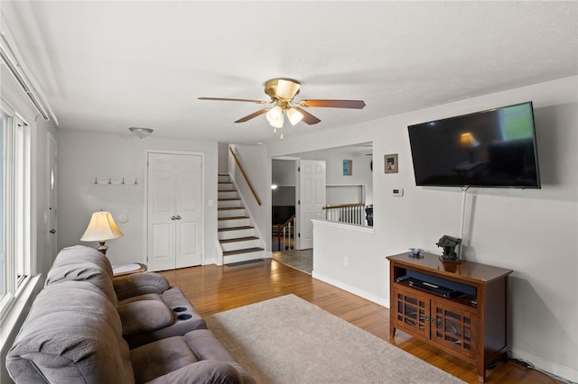 29 Davy Dr, Gates, NY 14624 - living area featuring wood finished floors, ceiling fan, and stairs