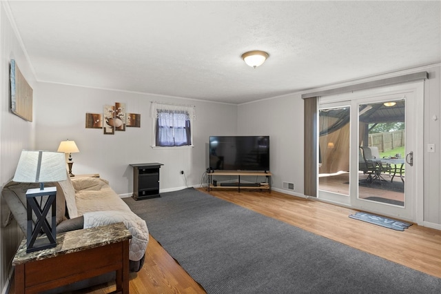 29 Davy Dr, Gates, NY 14624 - living room with wood finished floors, crown molding, and a textured ceiling