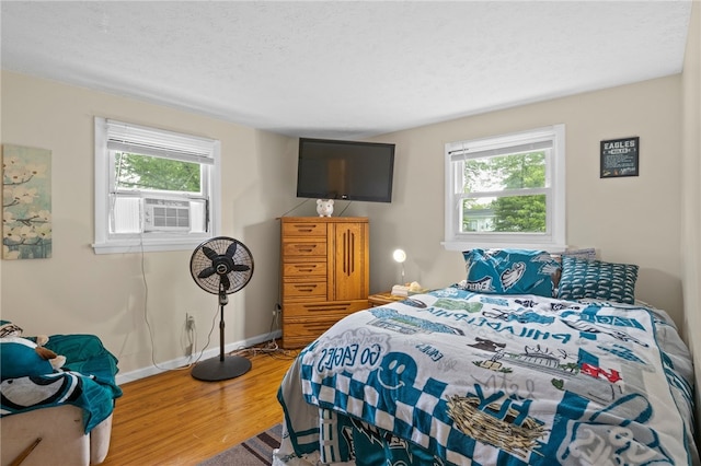 29 Davy Dr, Gates, NY 14624 - bedroom featuring cooling unit and wood finished floors