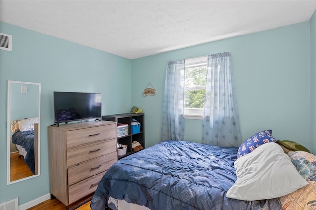 29 Davy Dr, Gates, NY 14624 - bedroom with wood finished floors and a textured ceiling