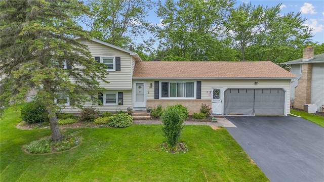 29 Davy Dr, Gates, NY 14624 - split level home featuring asphalt driveway, a garage, a front yard, and brick siding