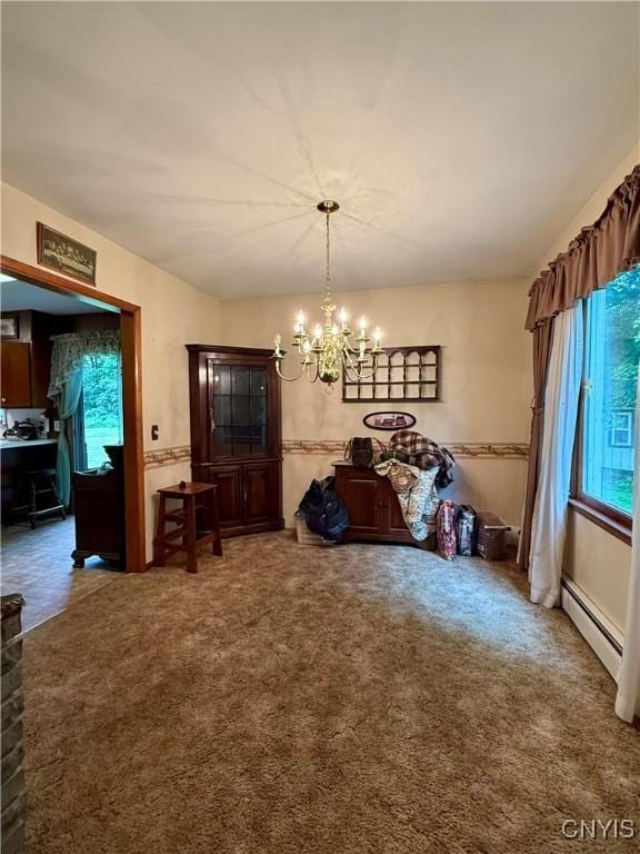 9418 Glenmore Rd Unit Es, Annsville, NY 13471 - carpeted dining space with plenty of natural light, a chandelier, and a baseboard heating unit