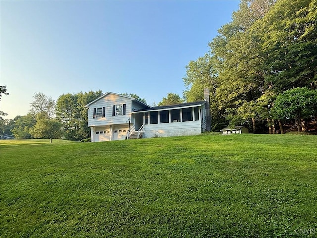 9418 Glenmore Rd Unit Es, Annsville, NY 13471 - view of front of property featuring a sunroom, a garage, a front lawn, and a chimney