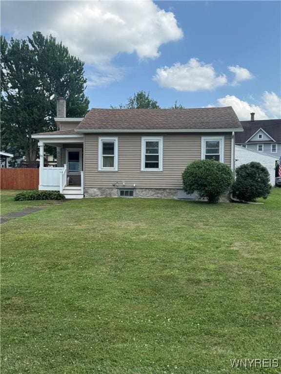 29 Church St, Royalton, NY 14105 - back of property with a lawn, a chimney, and a porch