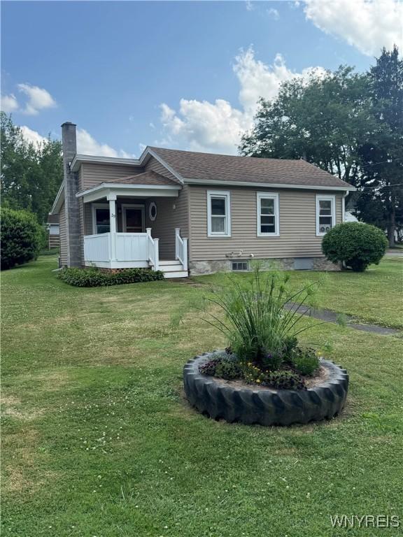 29 Church St, Royalton, NY 14105 - ranch-style house with a chimney and a front lawn