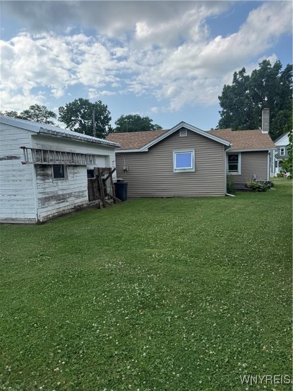 29 Church St, Royalton, NY 14105 - rear view of property with a lawn and a shingled roof