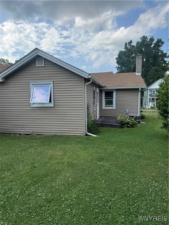 29 Church St, Royalton, NY 14105 - back of house with a lawn, a chimney, and roof with shingles