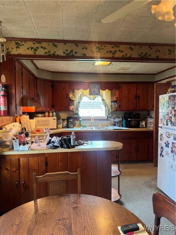29 Church St, Royalton, NY 14105 - kitchen featuring white appliances, light countertops, and brown cabinets