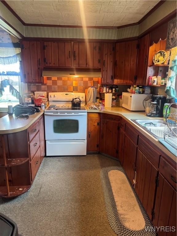 29 Church St, Royalton, NY 14105 - kitchen with white appliances, under cabinet range hood, light countertops, open shelves, and ornamental molding