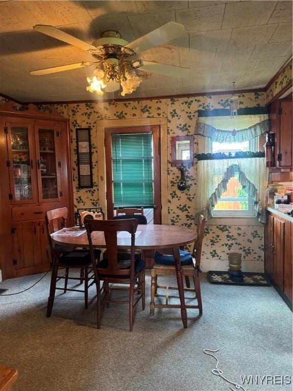 29 Church St, Royalton, NY 14105 - dining area with wallpapered walls, ceiling fan, and light colored carpet