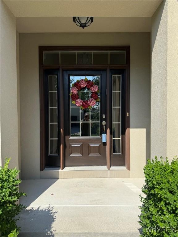 171 Harbridge Mnr, Amherst, NY 14221 - doorway to property featuring stucco siding
