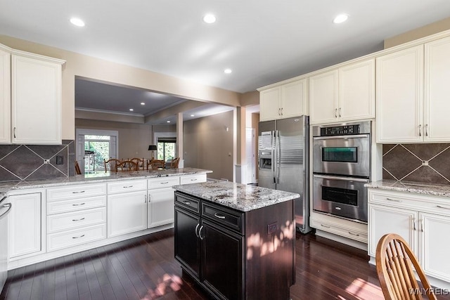171 Harbridge Mnr, Amherst, NY 14221 - kitchen featuring appliances with stainless steel finishes, dark wood-style flooring, backsplash, recessed lighting, and ornamental molding