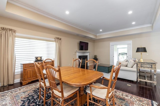 171 Harbridge Mnr, Amherst, NY 14221 - dining area with a tray ceiling, dark wood-type flooring, crown molding, a fireplace, and recessed lighting