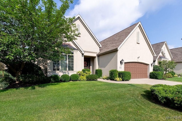 171 Harbridge Mnr, Amherst, NY 14221 - view of front facade with stucco siding, a front yard, concrete driveway, an attached garage, and a shingled roof