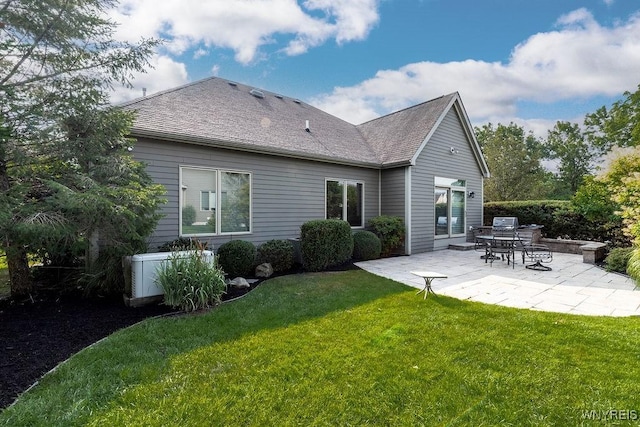 171 Harbridge Mnr, Amherst, NY 14221 - rear view of property featuring a patio, a lawn, and roof with shingles