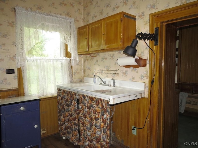 164 Kanzog Rd, German Flatts, NY 13407 - kitchen with wallpapered walls, brown cabinets, and light countertops