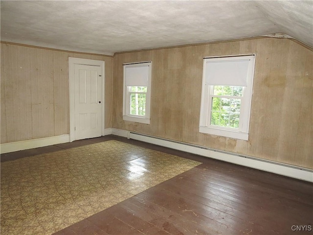 164 Kanzog Rd, German Flatts, NY 13407 - unfurnished room with wooden walls, hardwood / wood-style floors, baseboard heating, and lofted ceiling