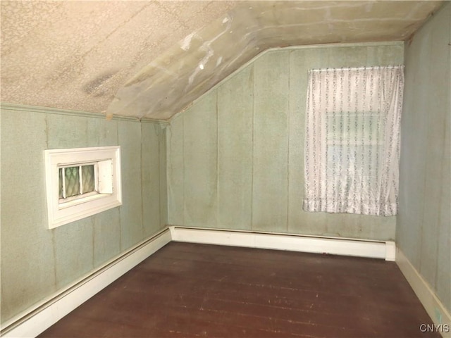164 Kanzog Rd, German Flatts, NY 13407 - bonus room featuring a baseboard heating unit, vaulted ceiling, and wood-type flooring