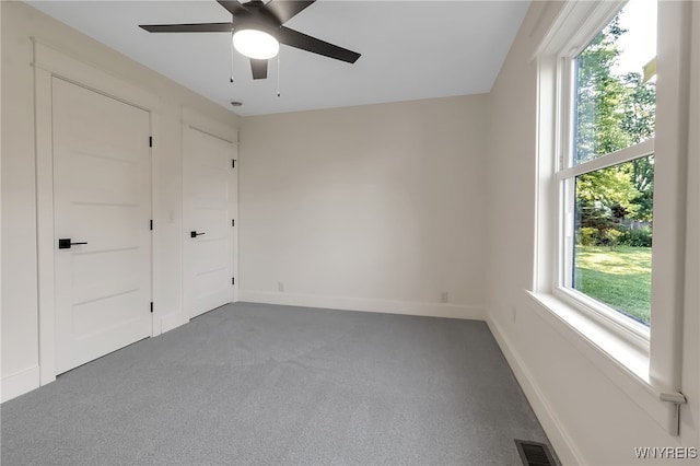 4221 Upper Mountain Rd, Cambria, NY 14132 - unfurnished bedroom featuring multiple windows, carpet flooring, and a ceiling fan