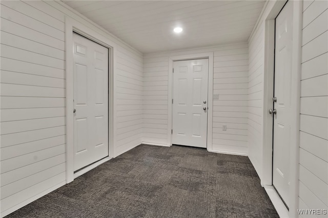 4221 Upper Mountain Rd, Cambria, NY 14132 - entrance foyer featuring dark carpet and wood walls