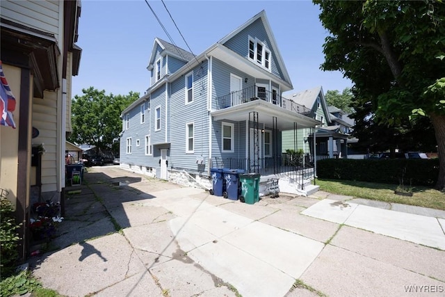54 Tuxedo Pl, Buffalo, NY 14207 - view of side of property featuring a balcony, covered porch, and concrete driveway