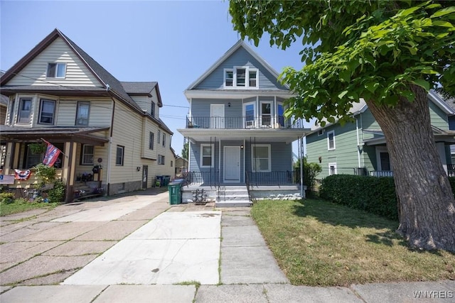 54 Tuxedo Pl, Buffalo, NY 14207 - american foursquare style home with a porch, a balcony, and a front lawn