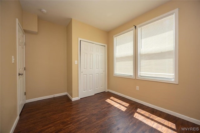 54 Tuxedo Pl, Buffalo, NY 14207 - unfurnished bedroom with dark wood-style floors and a closet
