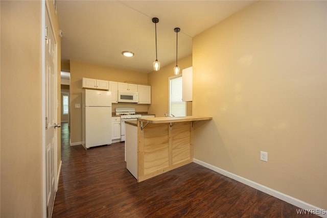 54 Tuxedo Pl, Buffalo, NY 14207 - kitchen with white appliances, a peninsula, a kitchen bar, dark wood-style floors, and white cabinets