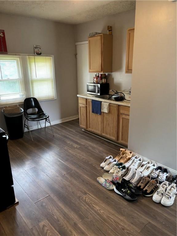 50 Saratoga Ave, Rochester, NY 14608 - kitchen with stainless steel microwave, dark wood finished floors, and light countertops
