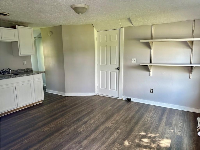 50 Saratoga Ave, Rochester, NY 14608 - kitchen with dark wood finished floors, white cabinets, a textured ceiling, and dark countertops